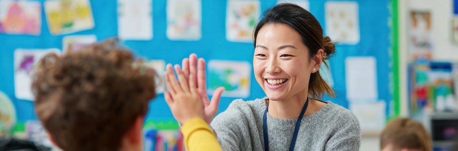 A teacher high-fiving a child.