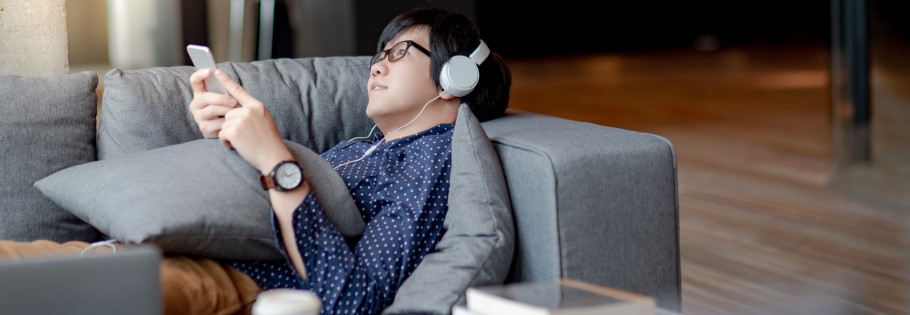 An image of a student listening to a podcast