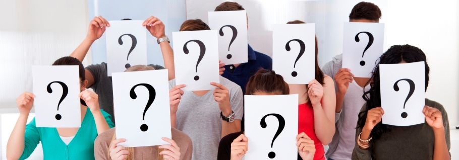 Image of students holding question mark boards