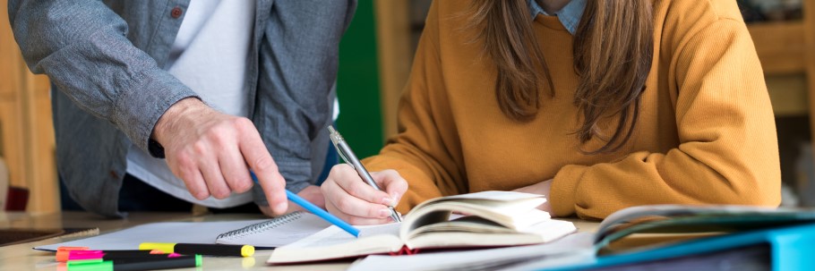 Image of a teacher supporting a student with coursework