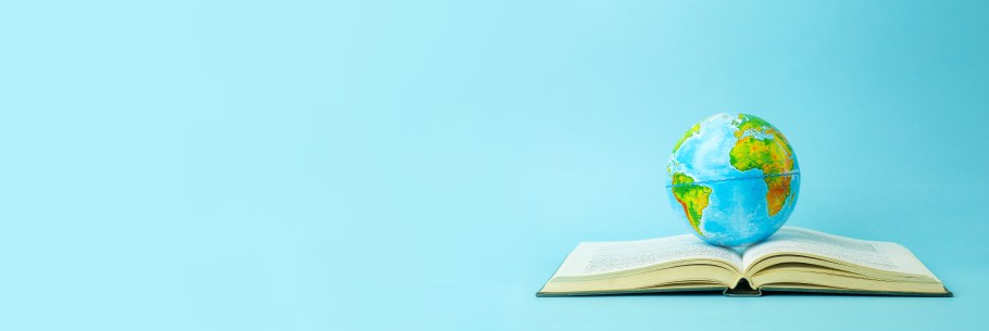 Image of a globe sat on an academic study book