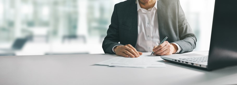 Image of a school teacher writing a university reference