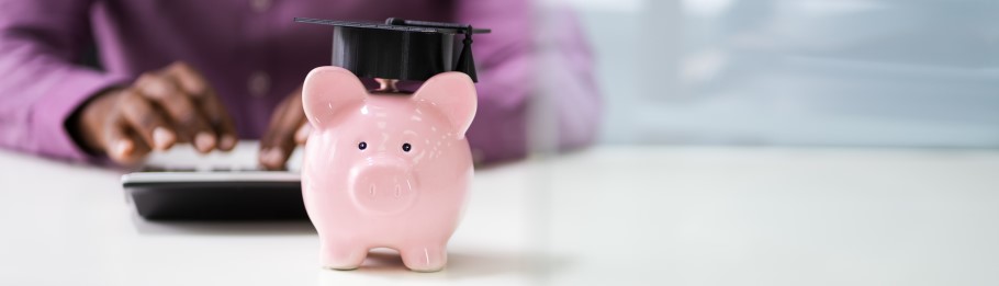 Image of a money bank with a graduation cap
