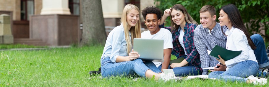 Image of a group of students relaxing on the grass
