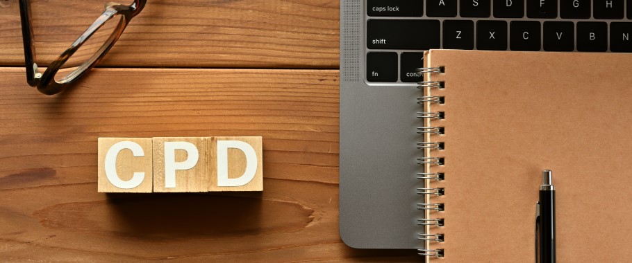 Image of a laptop, notebook and text "CPD"
