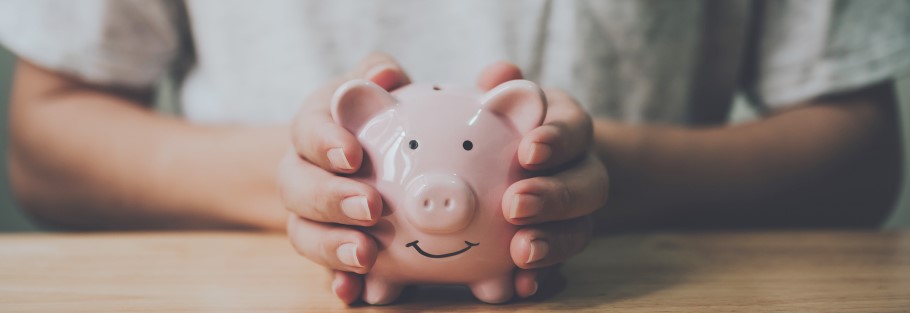 Image of a student holding a piggy bank